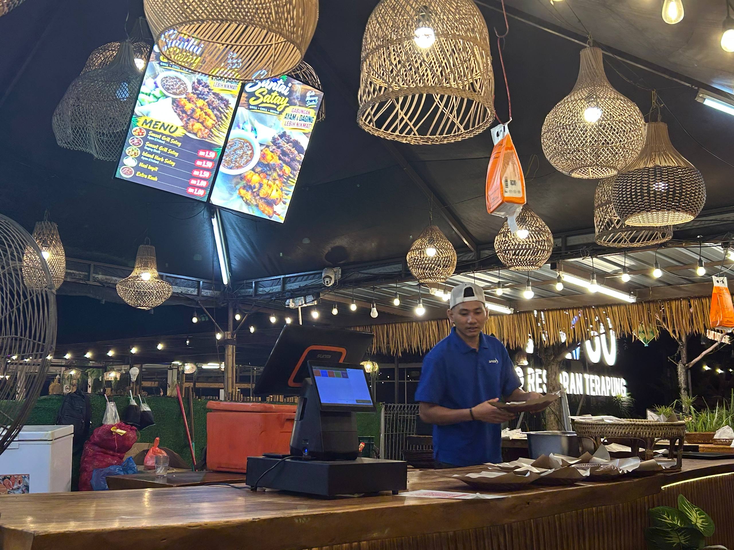 Evening service beneath woven lanterns.