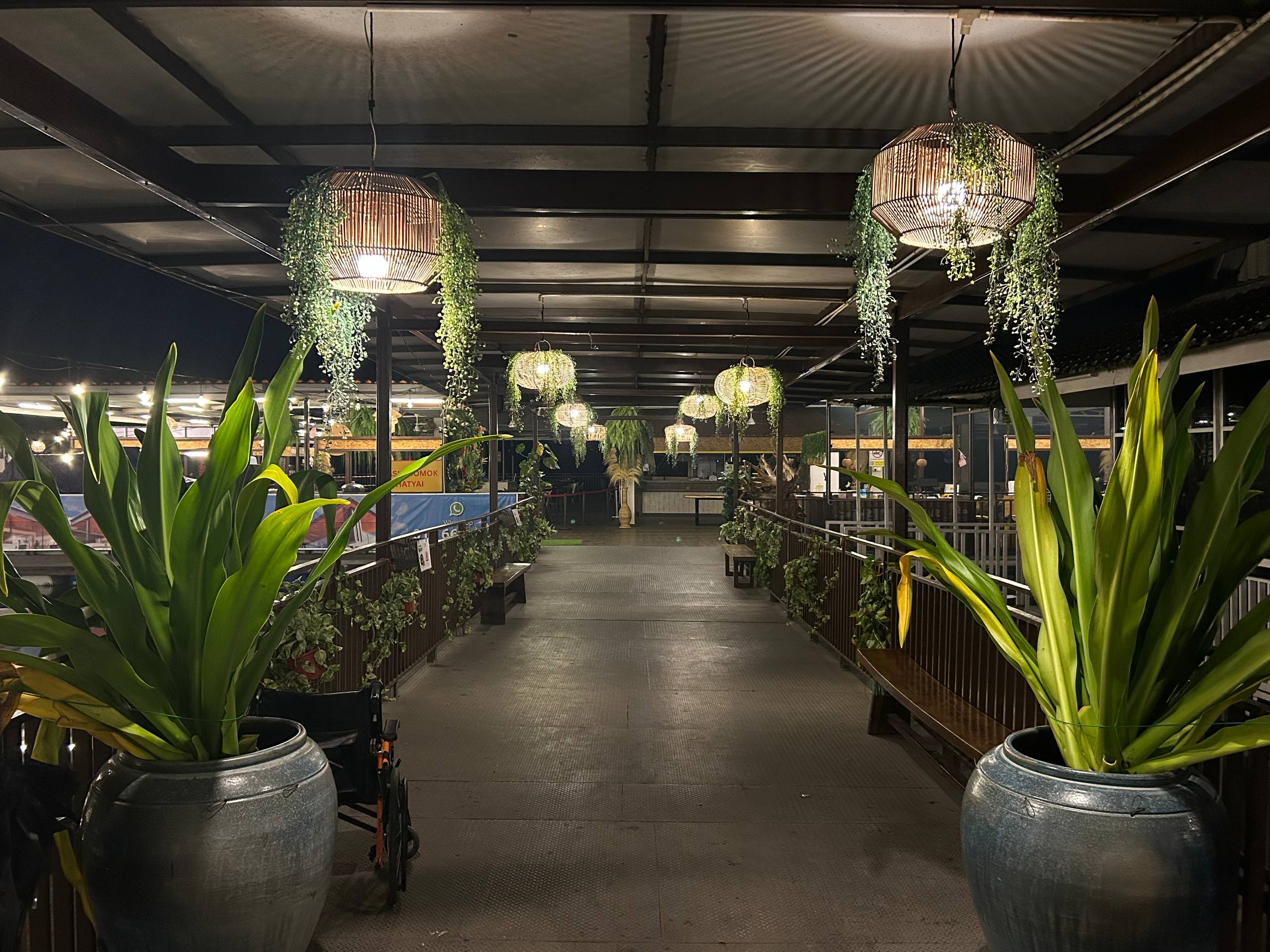 Plants and woven lanterns along the Araso walkway